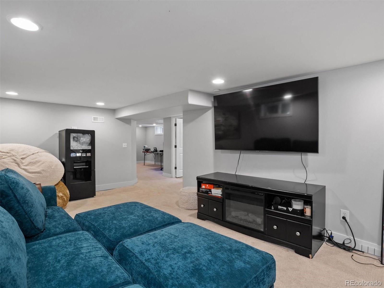 643 Jackson Street Denver, CO 80206 - Photo 33 of 40 a living room with furniture and a flat screen tv