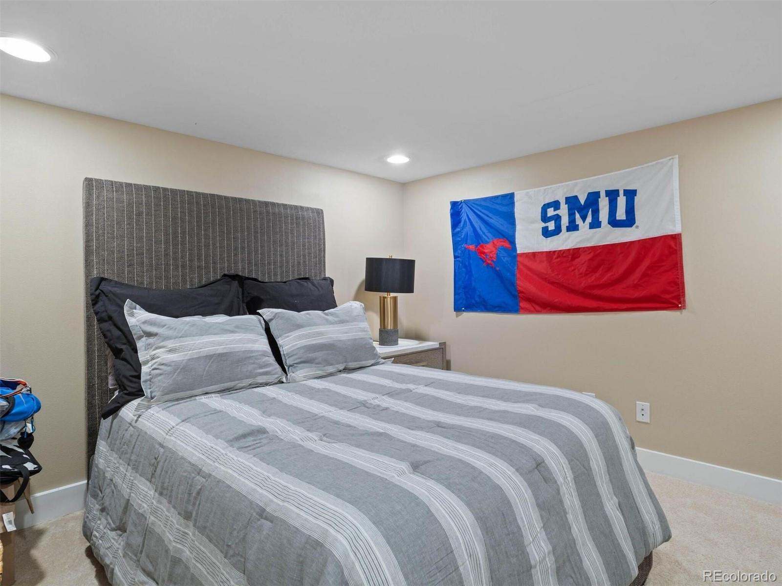 643 Jackson Street Denver, CO 80206 - Photo 34 of 40 a bedroom with double bed and a painting on the wall