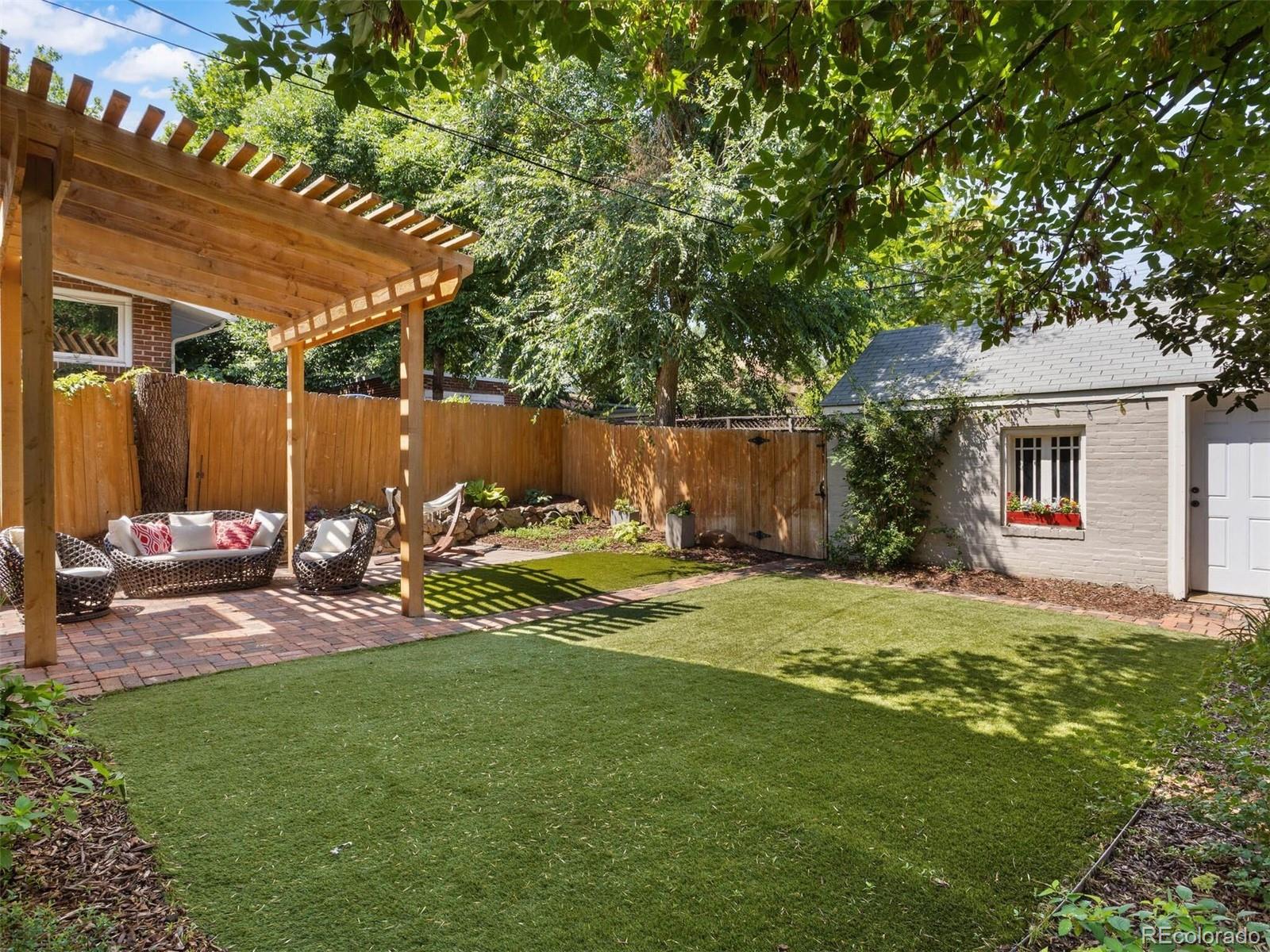 643 Jackson Street Denver, CO 80206 - Photo 37 of 40 a view of a backyard with table and chairs under an umbrella