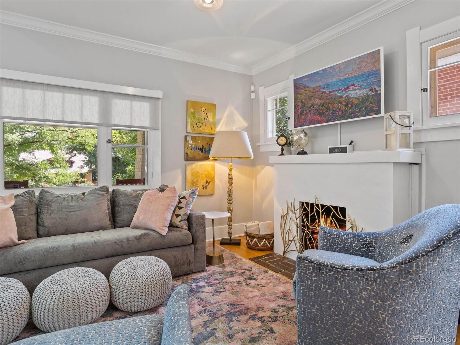 643 Jackson Street Denver, CO 80206 - Photo 9 of 40 a living room with furniture and a large window