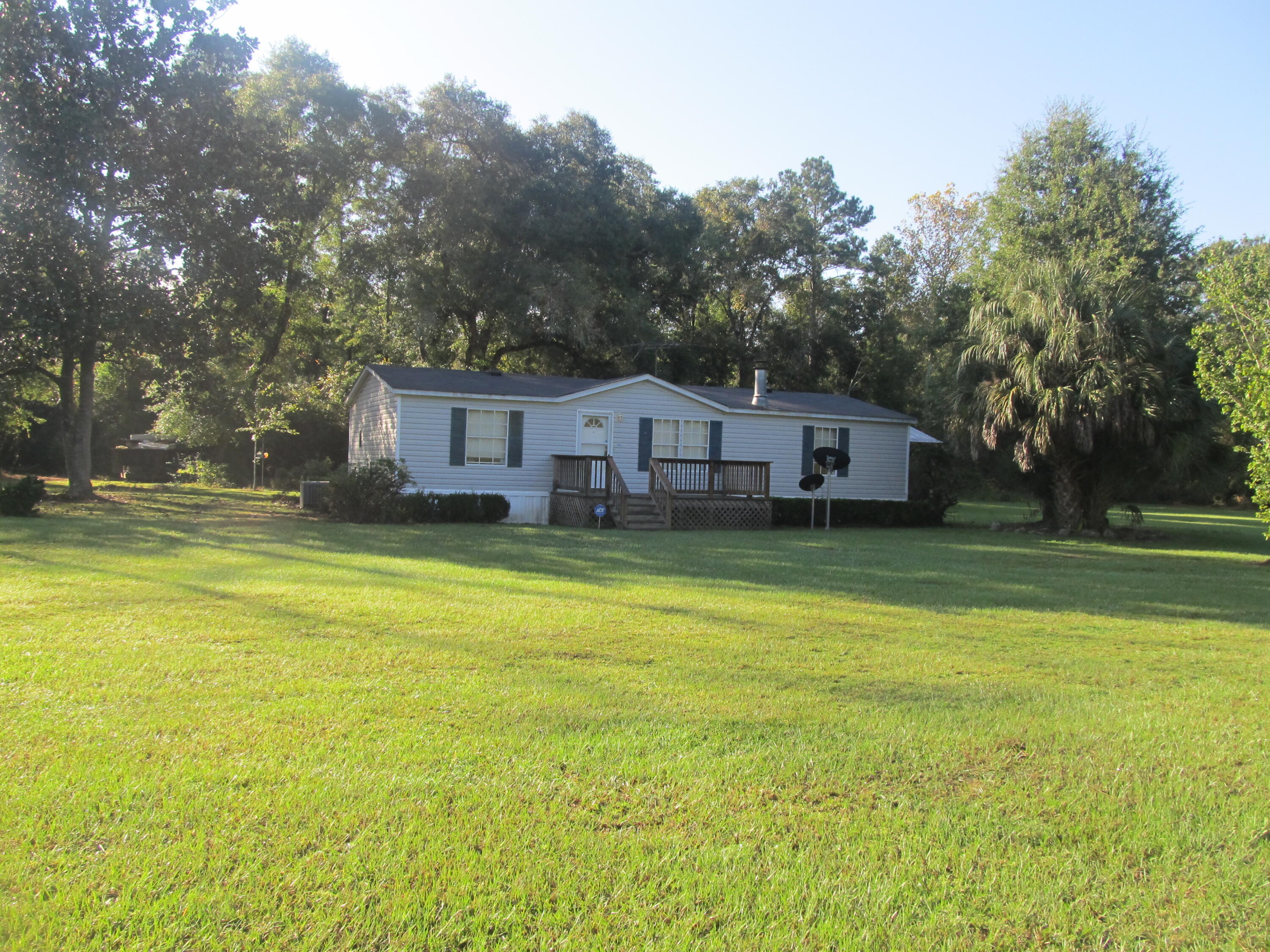 211 River Road Samson, AL 36477 - Photo 1 of 23 a view of a house with a swimming pool