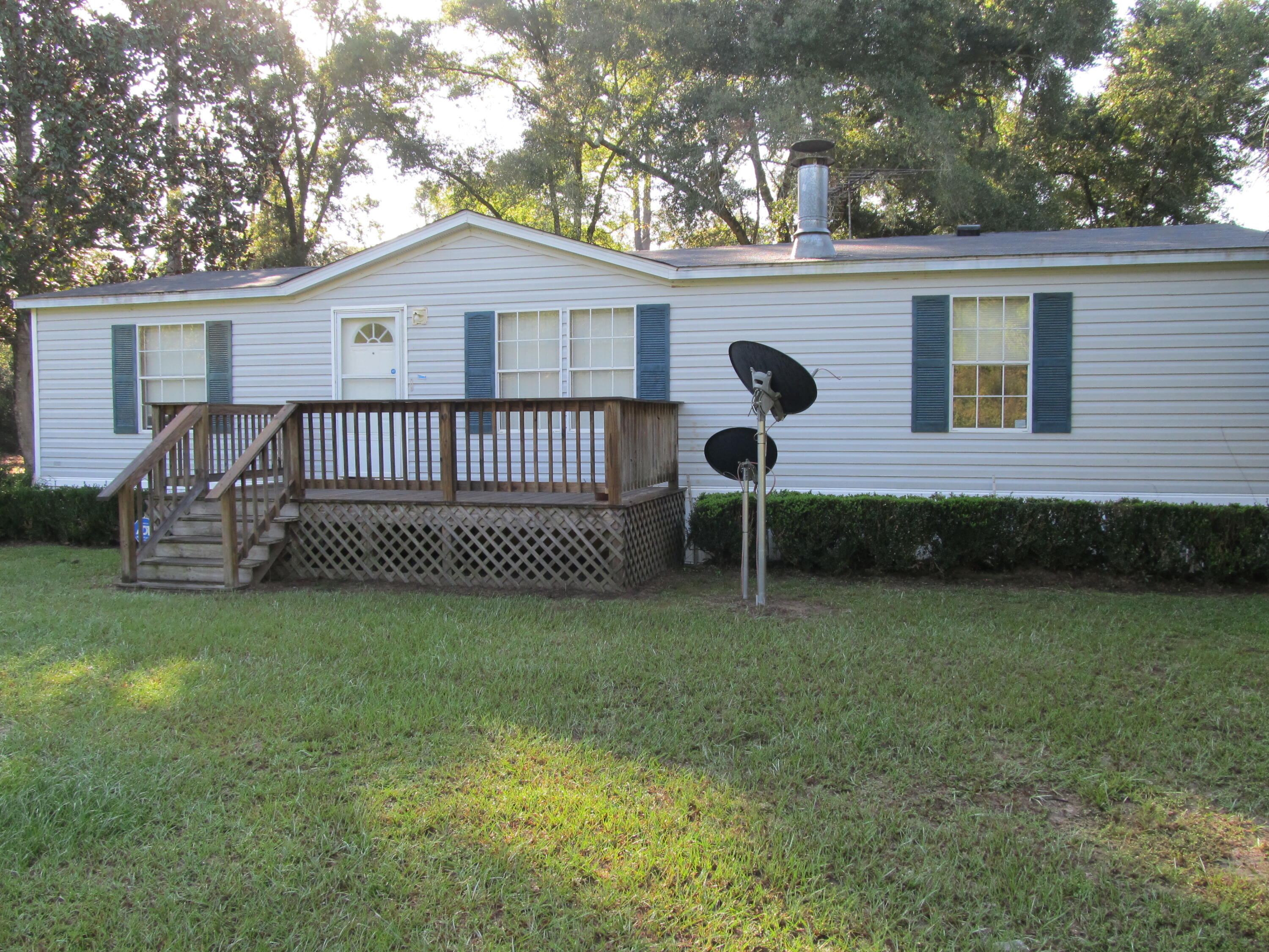 211 River Road Samson, AL 36477 - Photo 2 of 23 a view of a house with a yard and a garden