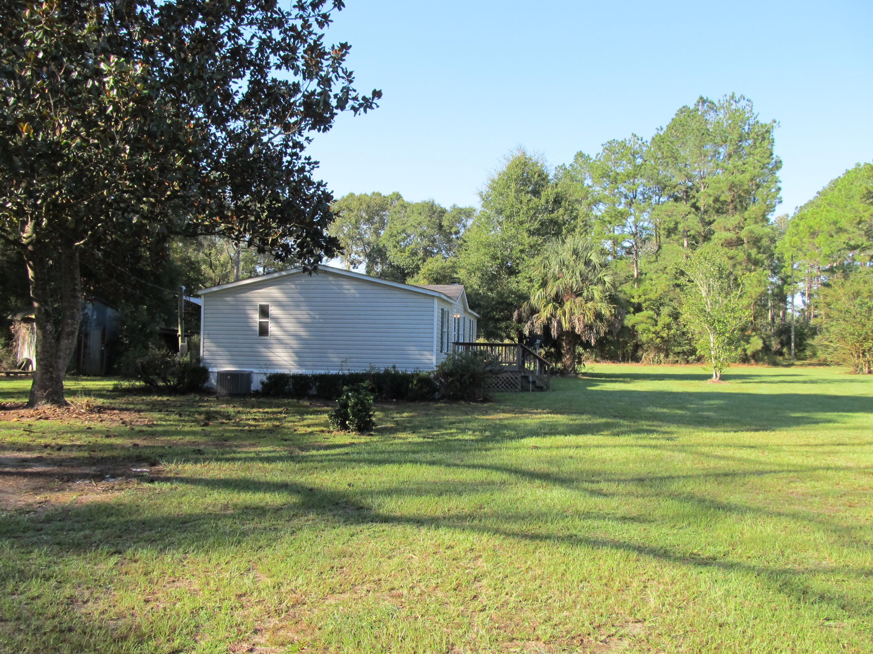 211 River Road Samson, AL 36477 - Photo 22 of 23 a view of a house with a yard