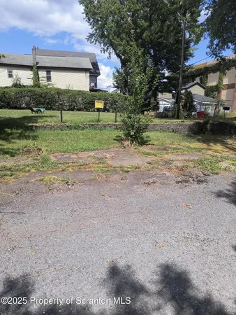 a front view of a house with a yard and lake view