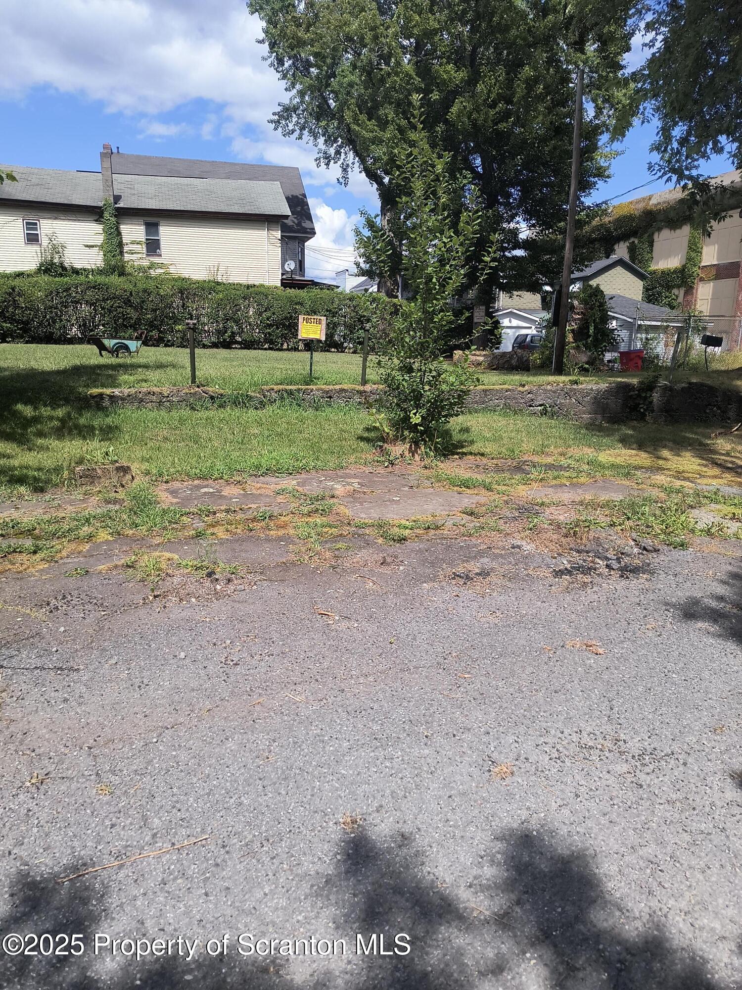a front view of a house with a yard and lake view