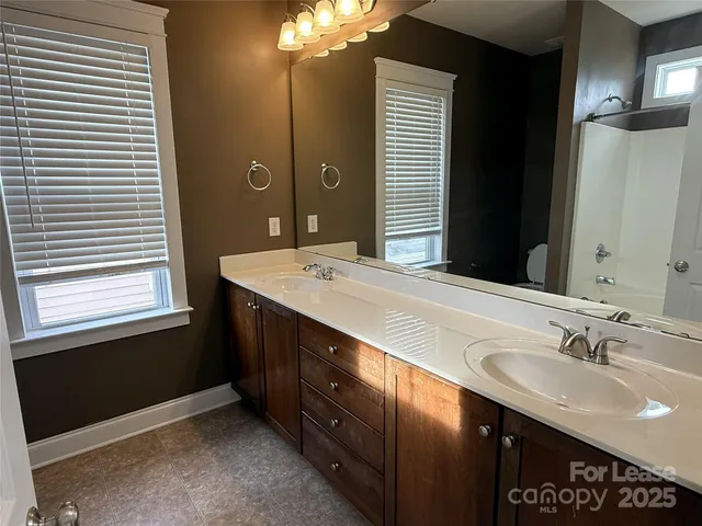 a bathroom with a sink double vanity and a mirror