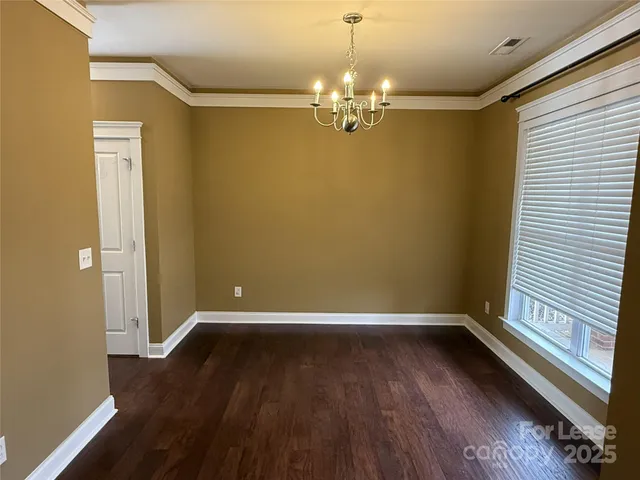 a view of room with window and wooden floor