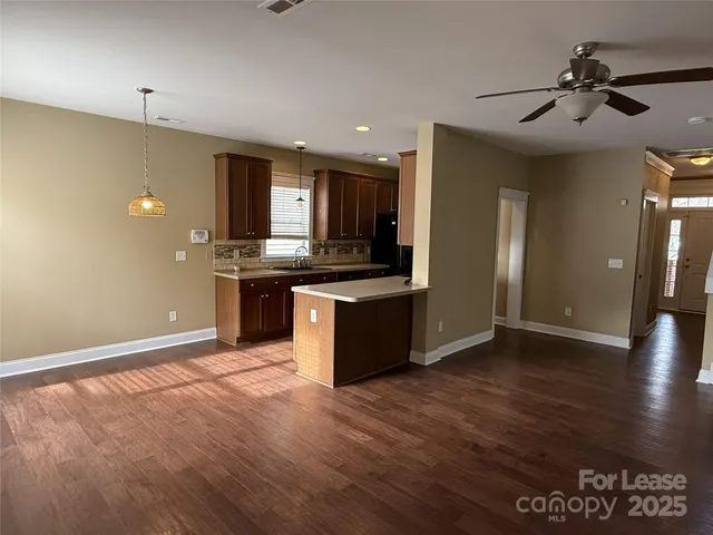 a view of kitchen with stainless steel appliances granite countertop a stove and a refrigerator