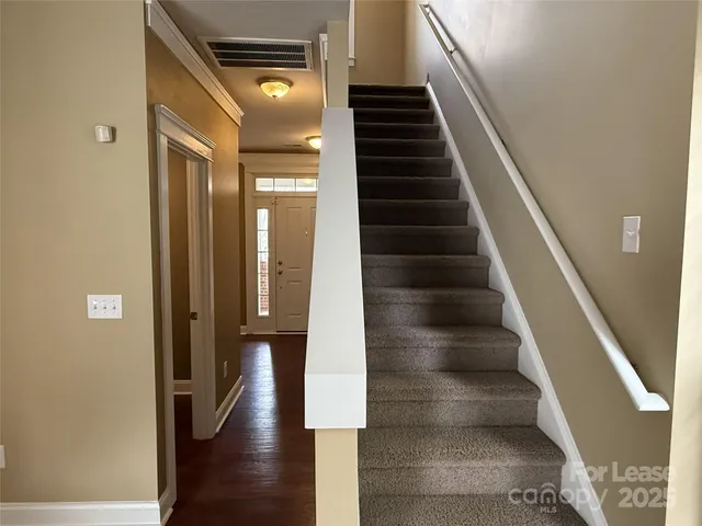 a view of entryway and hall with wooden floor