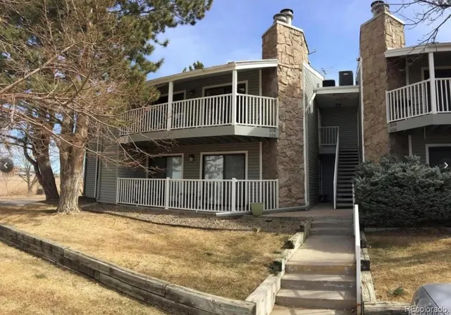 a house view with swimming pool and wooden fence