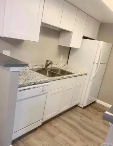 a kitchen with a sink and cabinets