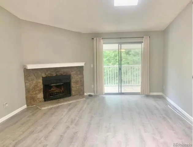 a view of empty room with a fireplace