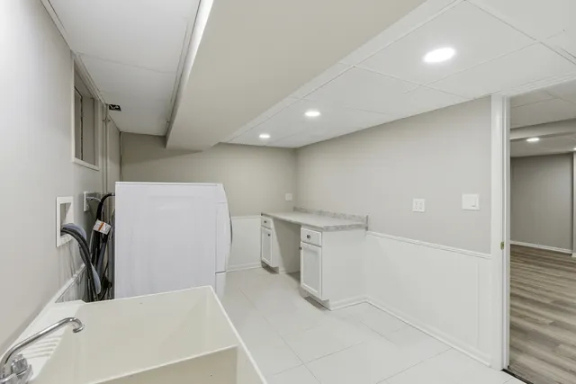 a view of a storage & utility room with two washing machine