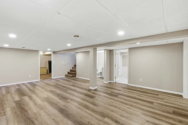 a view of empty room with wooden floor