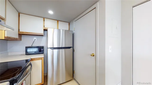 a kitchen with stainless steel appliances a refrigerator and a stove