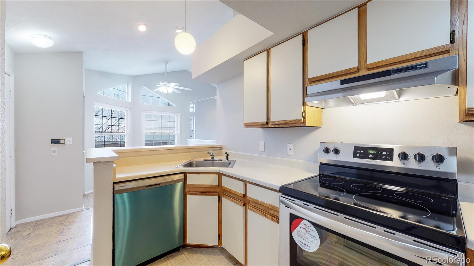 4760 South Wadsworth Boulevard, Unit F208 Littleton, CO 80123 - Photo 13 of 30 a kitchen that has a stove and a sink
