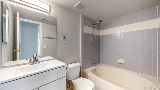 a bathroom with a sink toilet vanity and shower