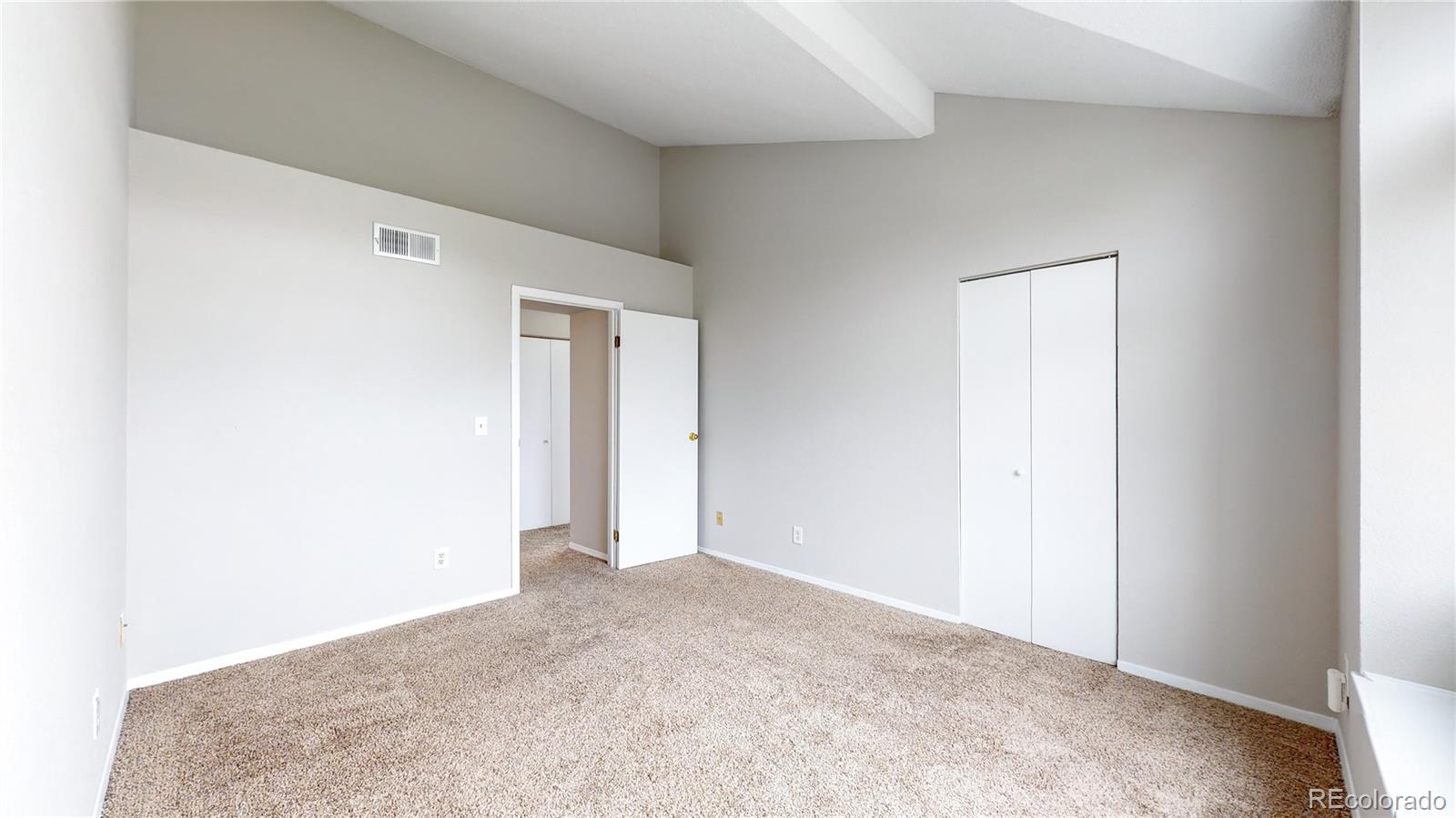 4760 South Wadsworth Boulevard, Unit F208 Littleton, CO 80123 - Photo 18 of 30 an empty room with closet and mirror