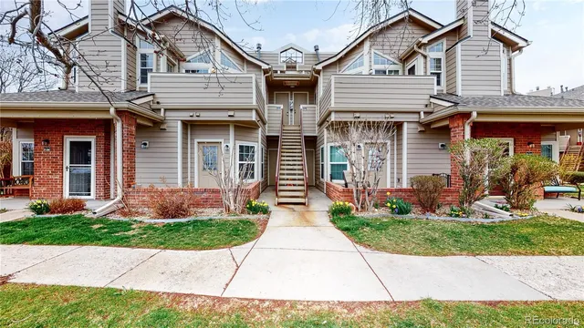 a front view of a house with a tree