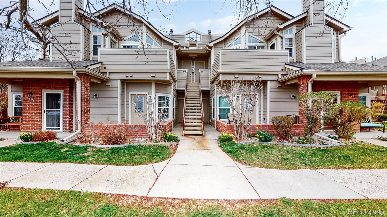 4760 South Wadsworth Boulevard, Unit F208 Littleton, CO 80123 - Photo 25 of 30 a front view of a house with garden