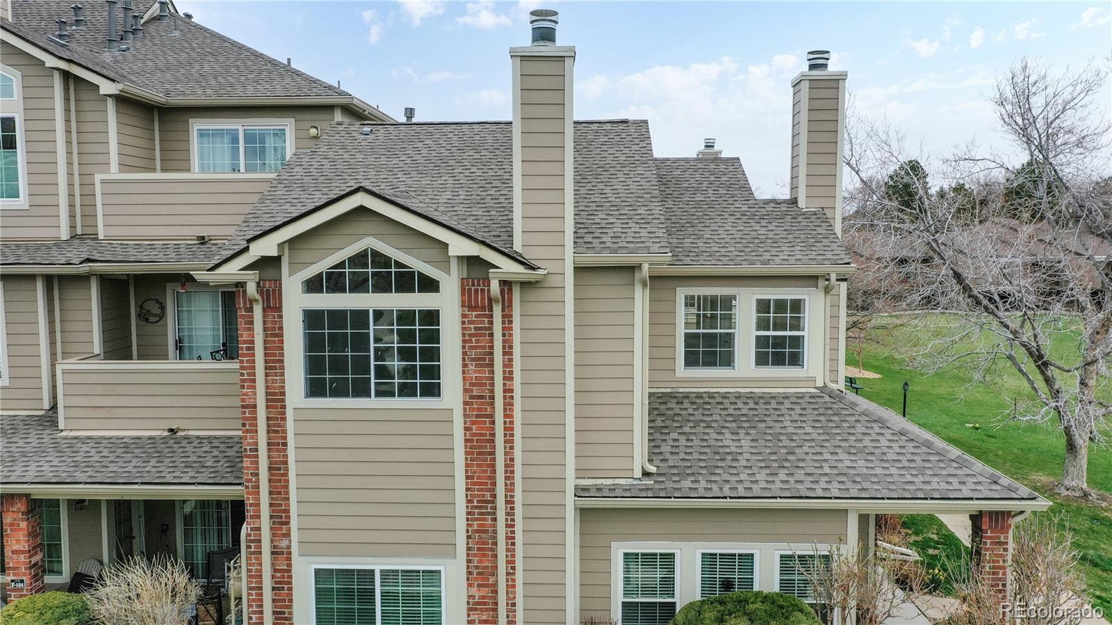 4760 South Wadsworth Boulevard, Unit F208 Littleton, CO 80123 - Photo 27 of 30 a front view of a house with a yard