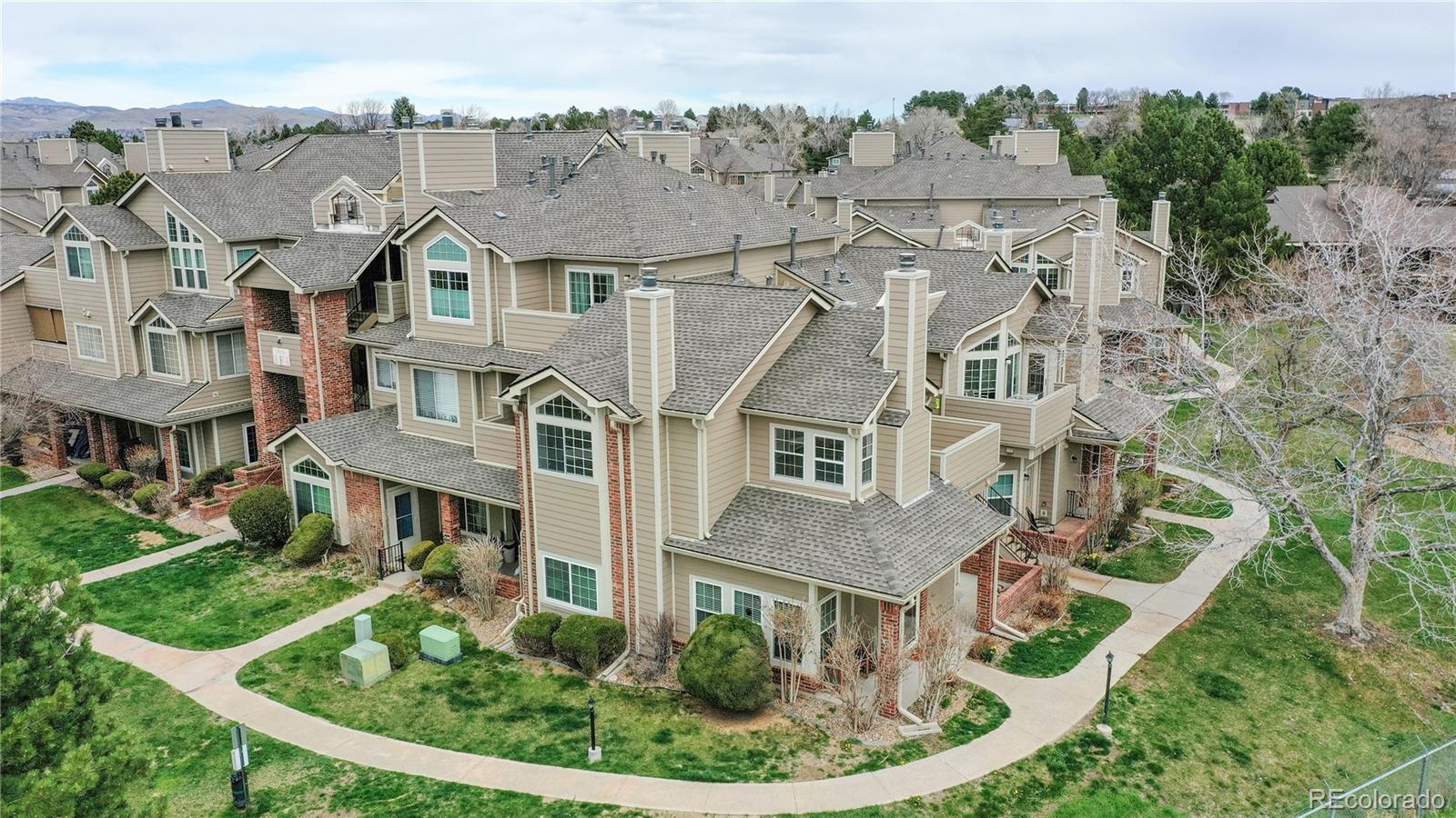4760 South Wadsworth Boulevard, Unit F208 Littleton, CO 80123 - Photo 29 of 30 an aerial view of residential houses with outdoor space and trees