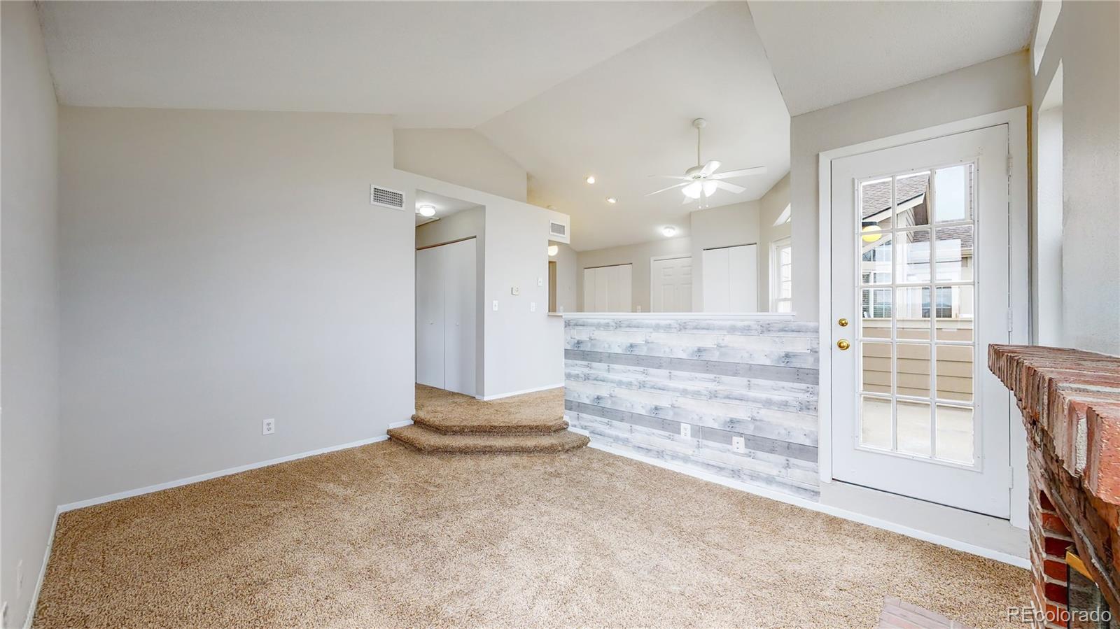 4760 South Wadsworth Boulevard, Unit F208 Littleton, CO 80123 - Photo 4 of 30 en empty room with windows