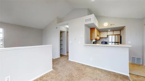 a view of a kitchen with a refrigerator a sink and a refrigerator