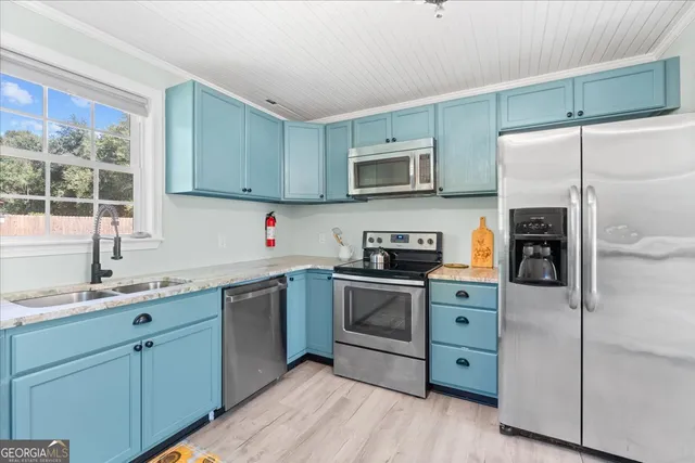 a kitchen with stainless steel appliances granite countertop a refrigerator sink and microwave