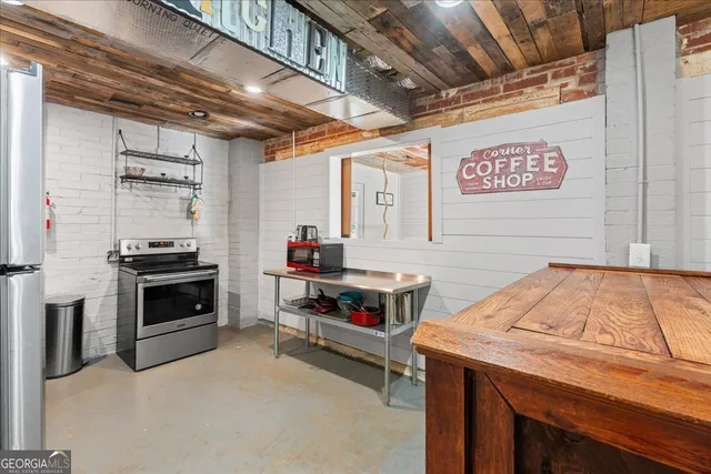 a kitchen with stainless steel appliances granite countertop a refrigerator and a stove
