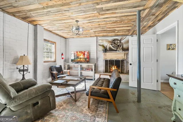 a living room with lots of furniture and a chandelier
