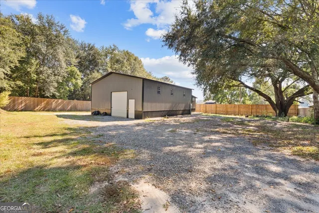 a backyard of a house with wooden fence