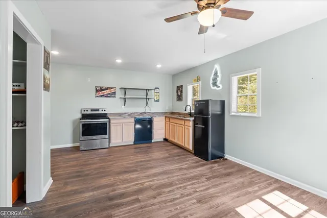 a kitchen with a stove top oven and refrigerator