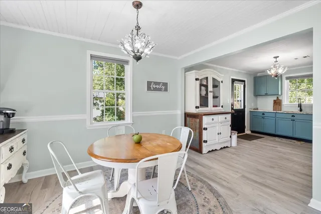 a view of a dining room with furniture and chandelier