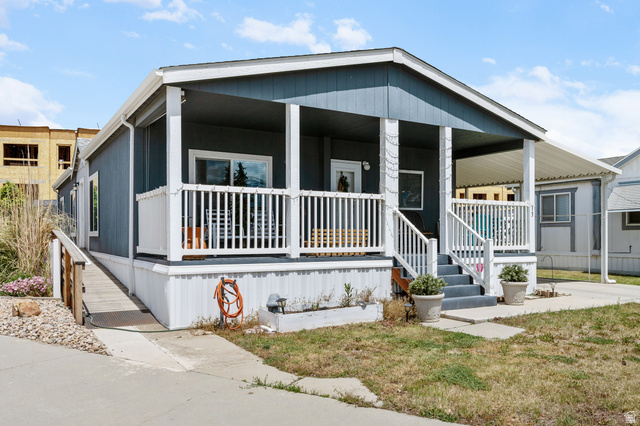 150 West 7500th South, Unit 13 Midvale, UT 84047 - Photo 1 of 32 Siding exterior with a covered porch and white railings