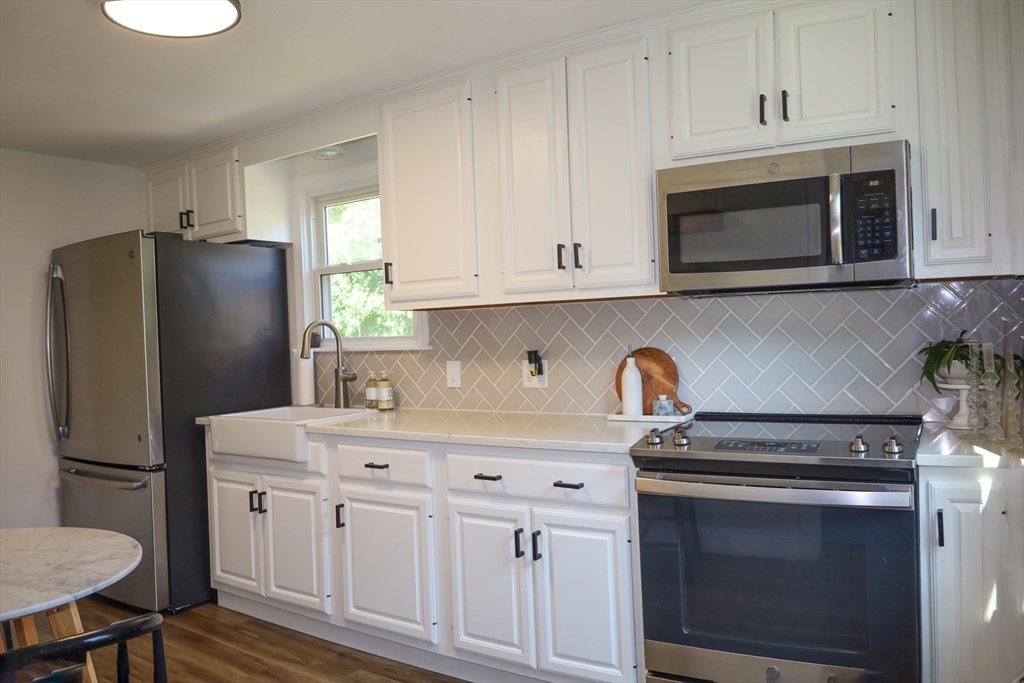 95 Mayflower Road Springfield, MA 01118 - Photo 8 of 20 a kitchen with stainless steel appliances a stove microwave and refrigerator