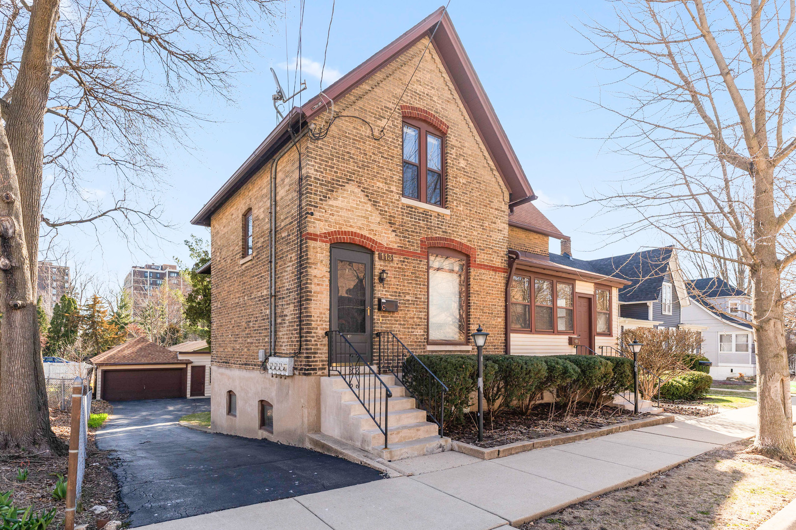 113 Elm Street, Unit C Elgin, IL 60123 - Photo 1 of 14 a view of a building with a bench in front of building