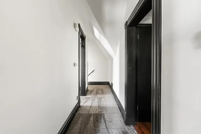 a view of a hallway with a white walls