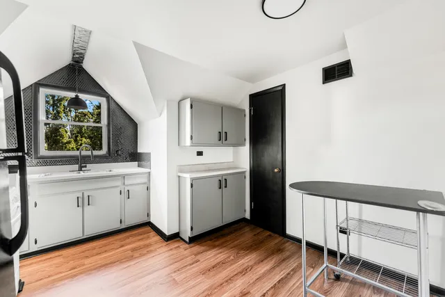 a view of cabinets with wooden floor and windows