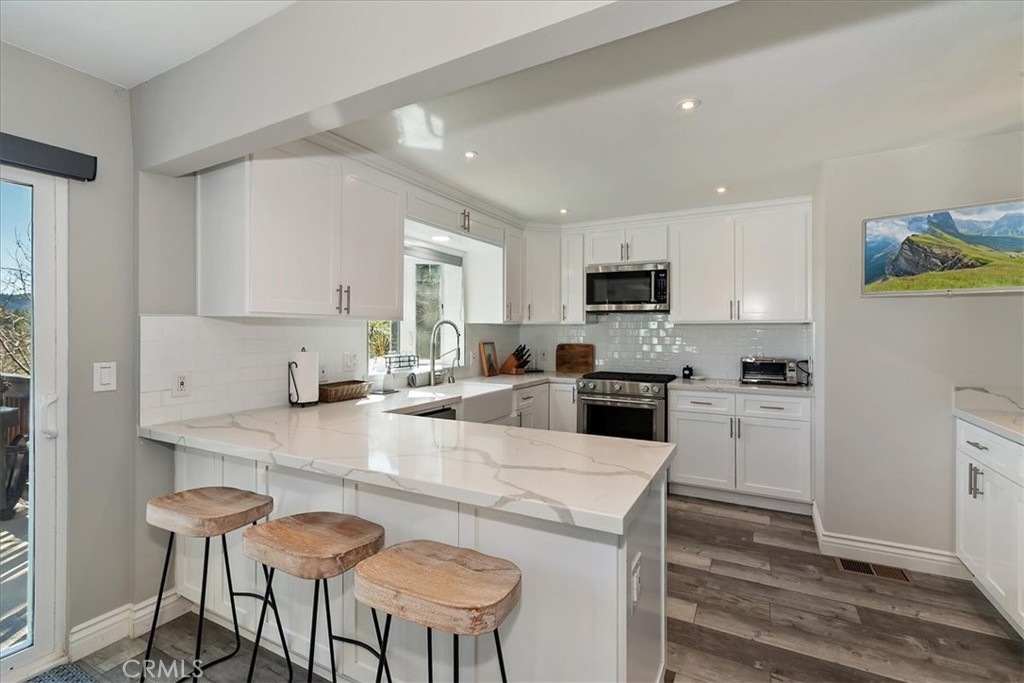 27565 North Bay Road Lake Arrowhead, CA 92352 - Photo 13 of 58 a kitchen with a dining table chairs and a refrigerator