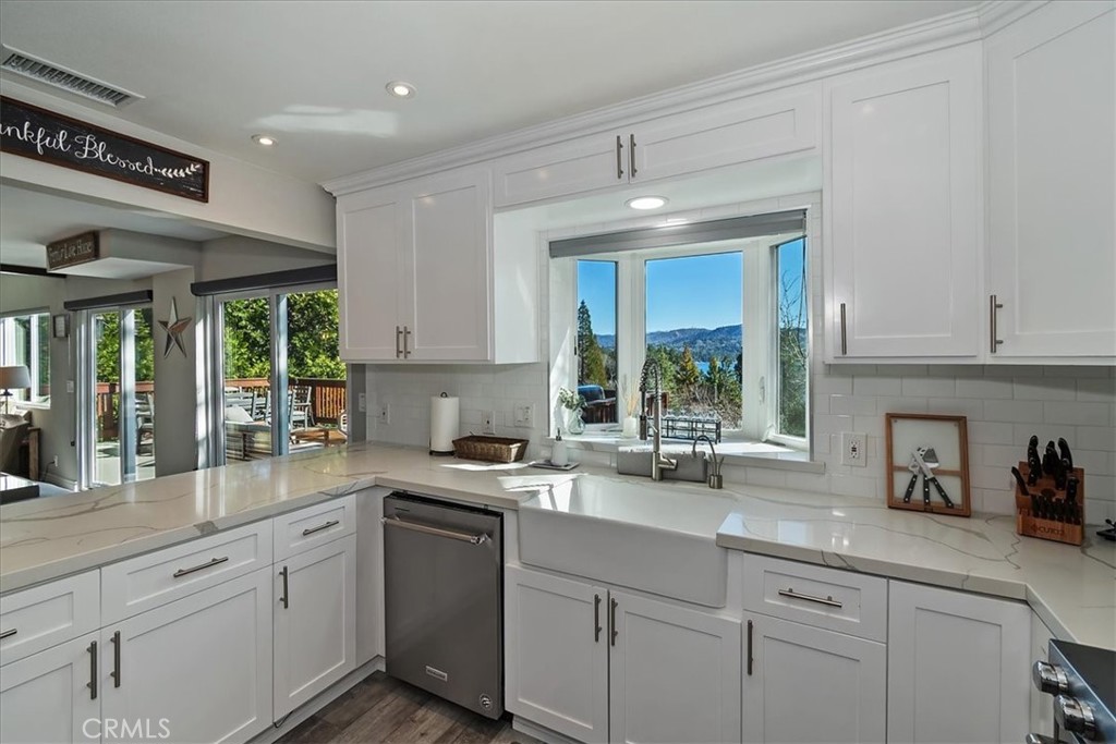 27565 North Bay Road Lake Arrowhead, CA 92352 - Photo 16 of 58 a kitchen with a sink window and cabinets