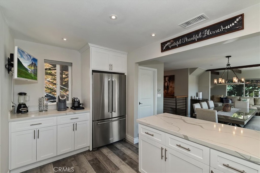 27565 North Bay Road Lake Arrowhead, CA 92352 - Photo 17 of 58 a kitchen with a refrigerator and cabinets