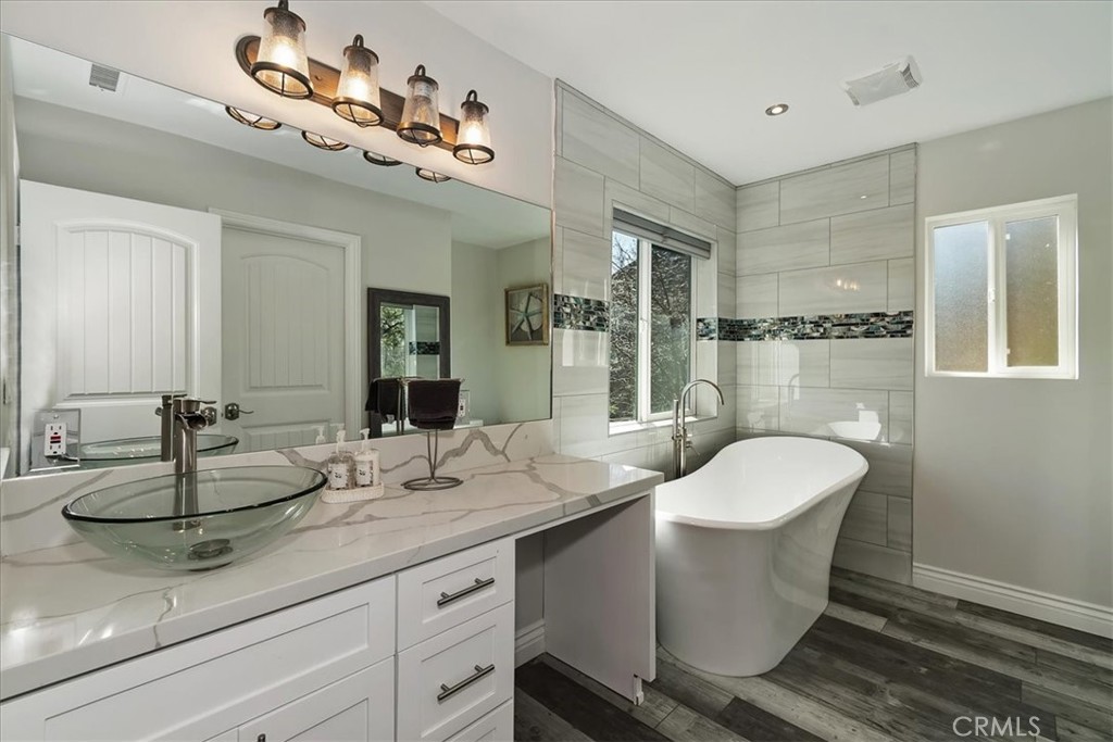 27565 North Bay Road Lake Arrowhead, CA 92352 - Photo 24 of 58 a bathroom with a double vanity sink and mirror