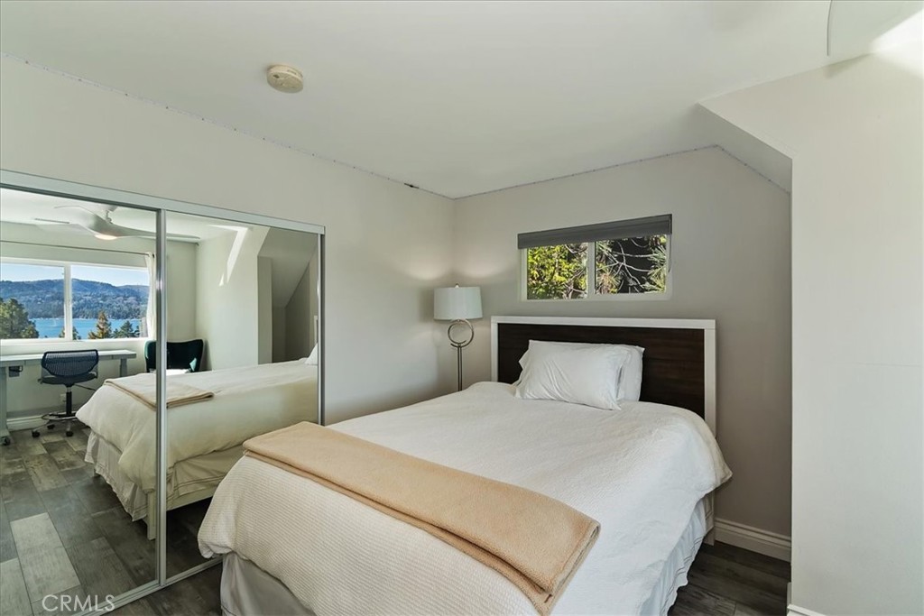 27565 North Bay Road Lake Arrowhead, CA 92352 - Photo 29 of 58 a bedroom with a large bed and a large window