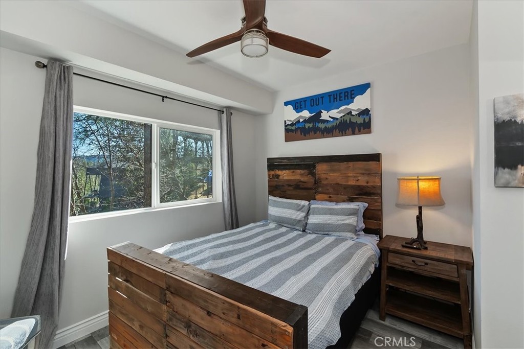 27565 North Bay Road Lake Arrowhead, CA 92352 - Photo 39 of 58 a bedroom with a bed and a flat screen tv