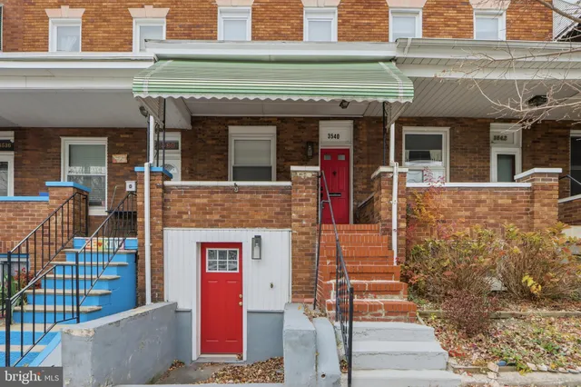 a view of a house with brick walls