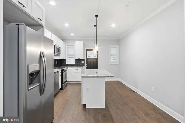 a view of a hallway with washer and dryer