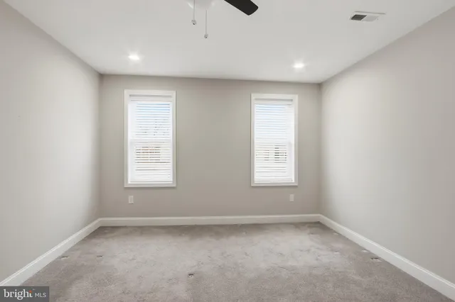 a bathroom with a granite countertop sink vanity and mirror