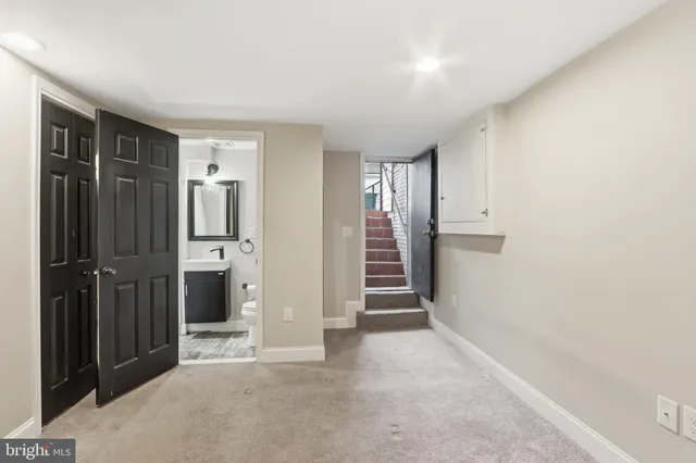 an empty room with closet and entryway