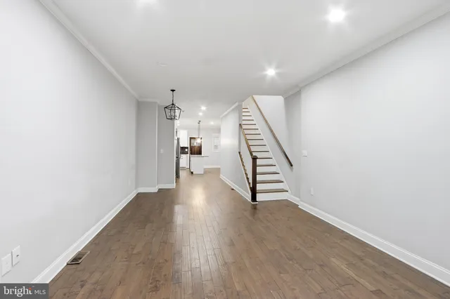 a kitchen with stainless steel appliances kitchen island a white cabinets and refrigerator